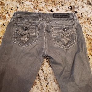 Pair of Grey Rock Revivals Skinny Jeans
